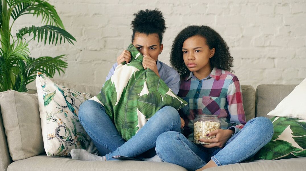 children watching tv together