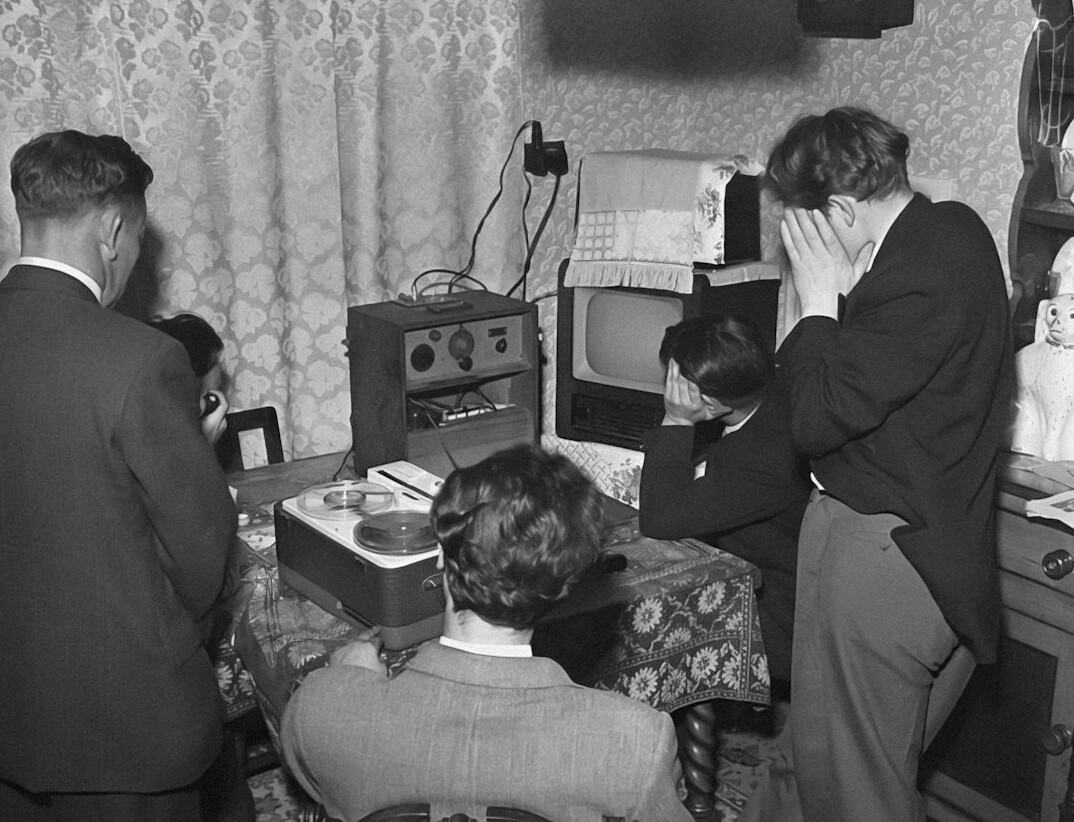 group watching old tv